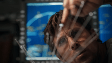 Ryan Gosling as Ryland Grace examining scientific equipment aboard a spacecraft in Project Hail Mary, one of the major popcorn movies coming in spring 2026.