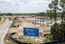 Walmart Supercenter construction site with steel framework and workers in Odessa, Florida